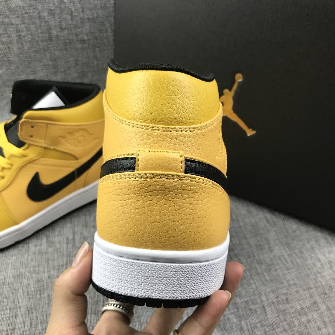 Air Jordan 1 Mid Yellow Ochre Sneakers in Black 554724-700 - product image from the listing.
