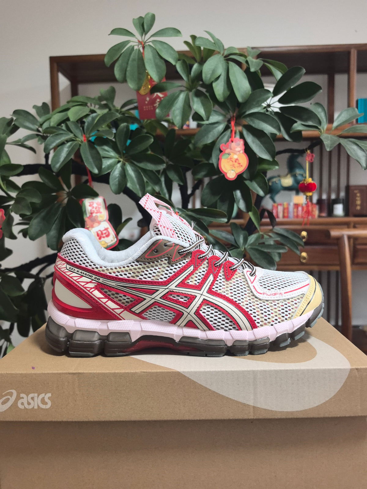 ASICS Gel-Kayano 22 Running Sneakers in White and Red - product image from the listing.