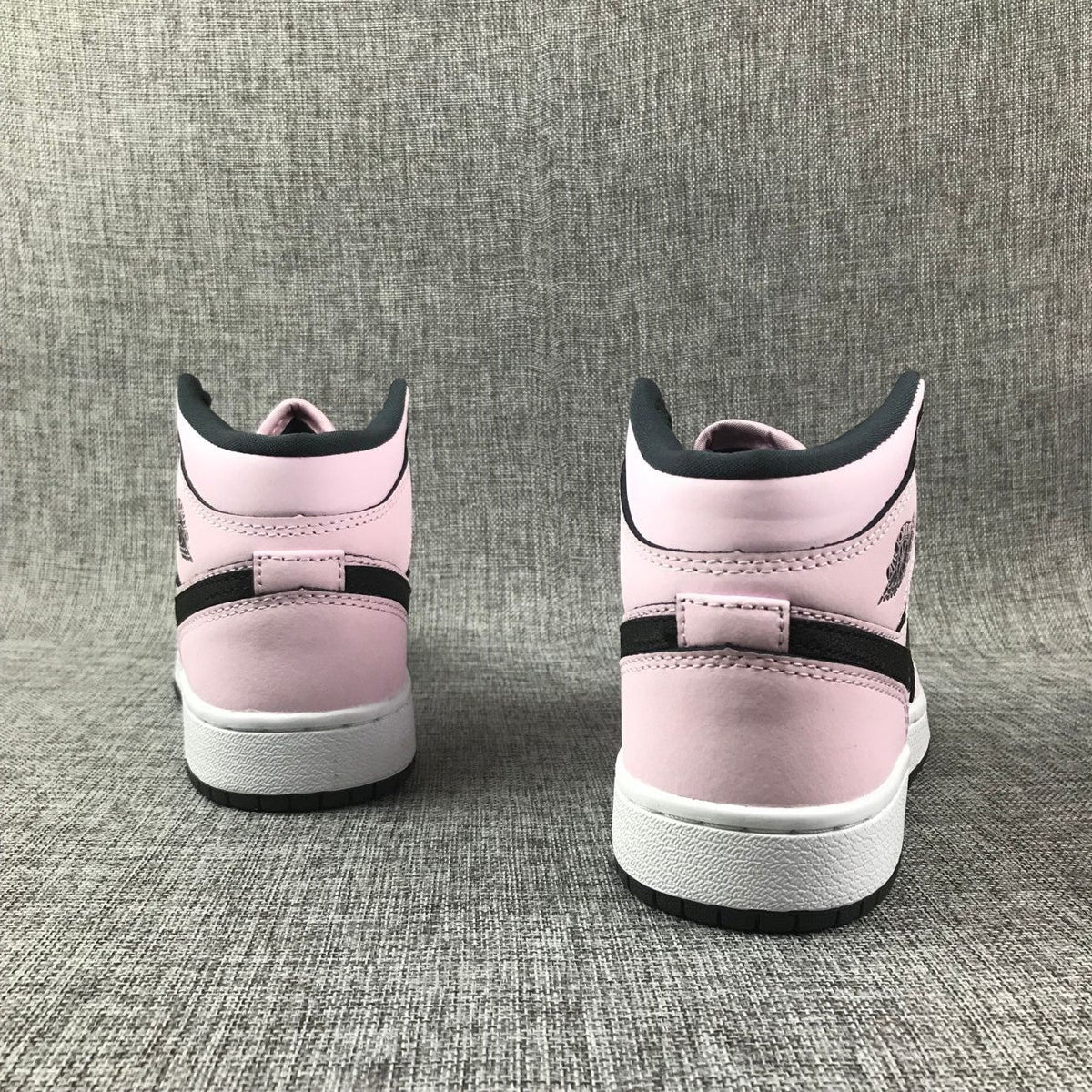 Air Jordan 1 Mid High-Top Sneakers in Pink and Black - product image from the listing.