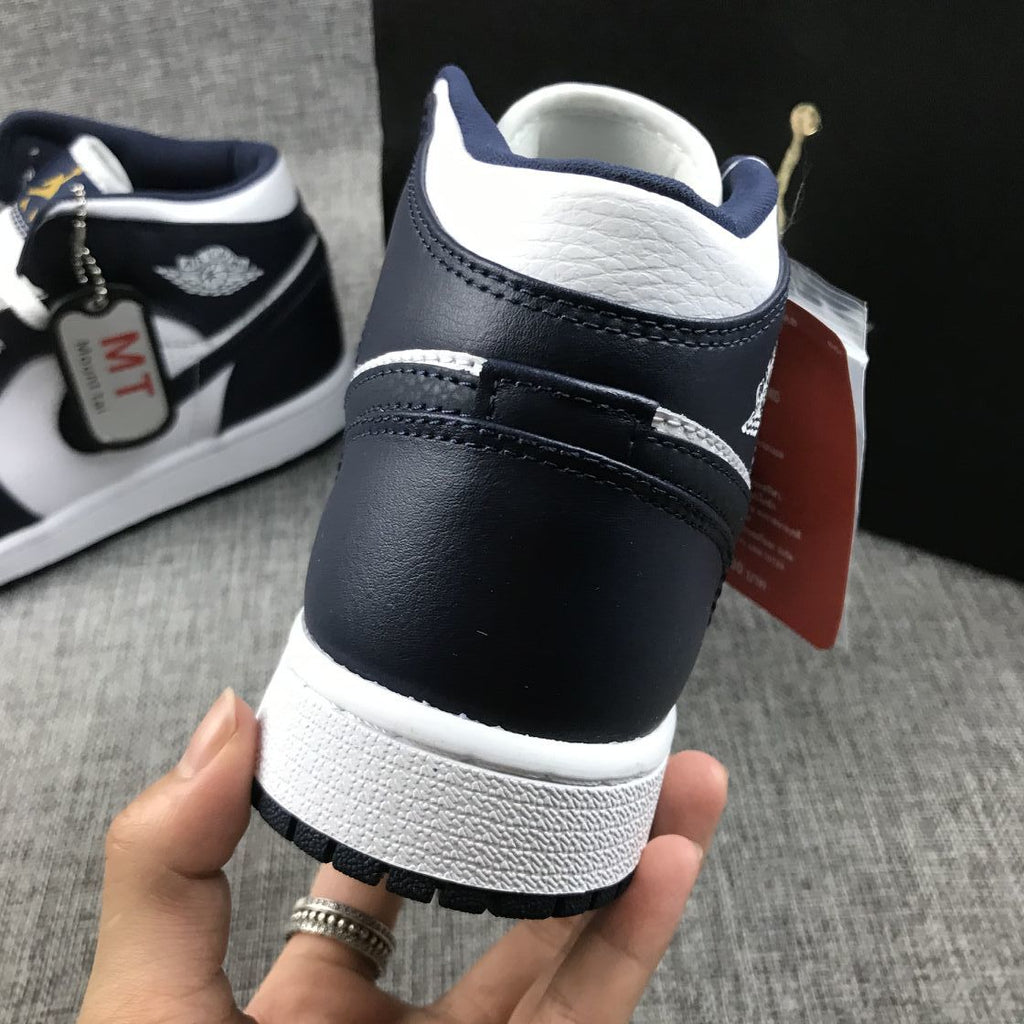 What The Obsidian Sneakers - Jordan 1 Mid 554724-174 - product image from the listing.