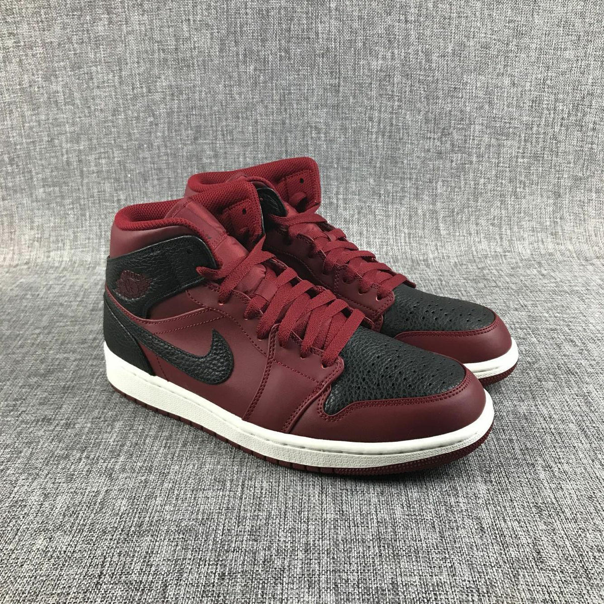 Air Jordan 1 Mid Sneakers in Black and Burgundy 554724-601 - product image from the listing.