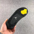 Air Jordan 4 Thunder Black Yellow Sneakers - product image from the listing.
