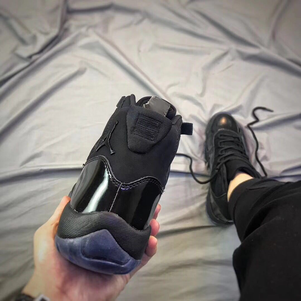 Air Jordan 11 Cap and Gown High-Top Sneakers in Black - product image from the listing.