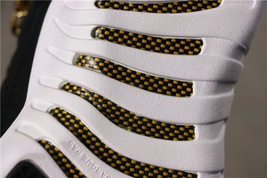 Air Jordan 12 Reverse Taxi Sneakers Black 153265-017 - product image from the listing.