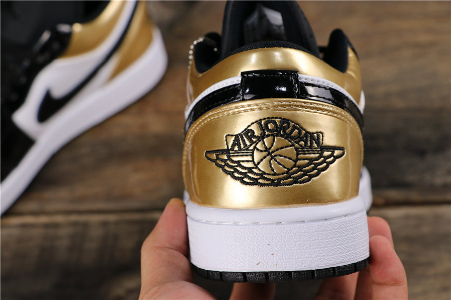 Jordan 1 Low Sneakers in Black Gold CQ9447-700 - product image from the listing.
