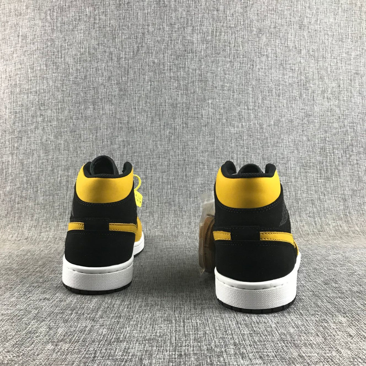 Air Jordan 1 Mid Sneakers in Black and Yellow - product image from the listing.