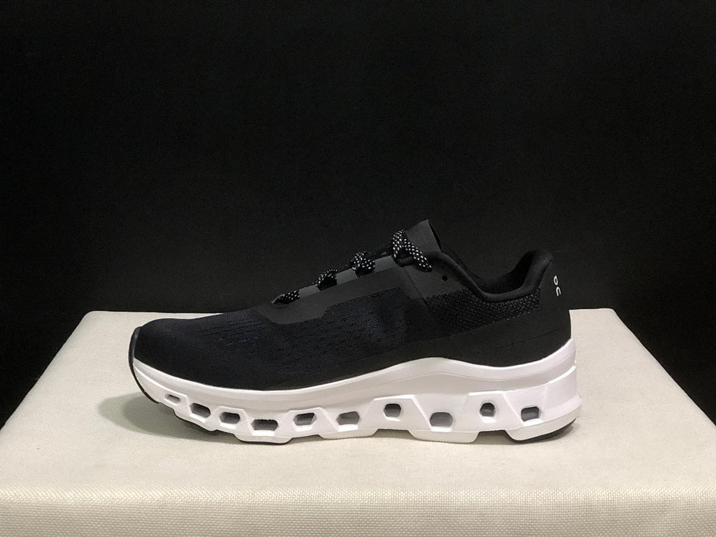 On Cloudmonster Running Sneakers in Black and White - product image from the listing.