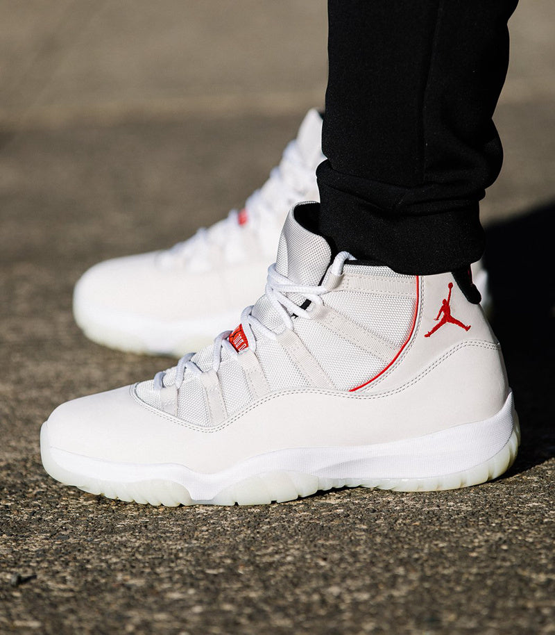 Air Jordan 11 Platinum Tint White High-Top Sneakers - product image from the listing.
