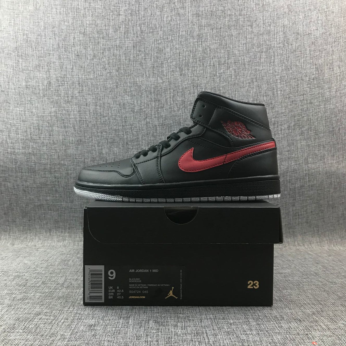 Air Jordan 1 Mid Sneakers in Black and Red 554724-045 - product image from the listing.
