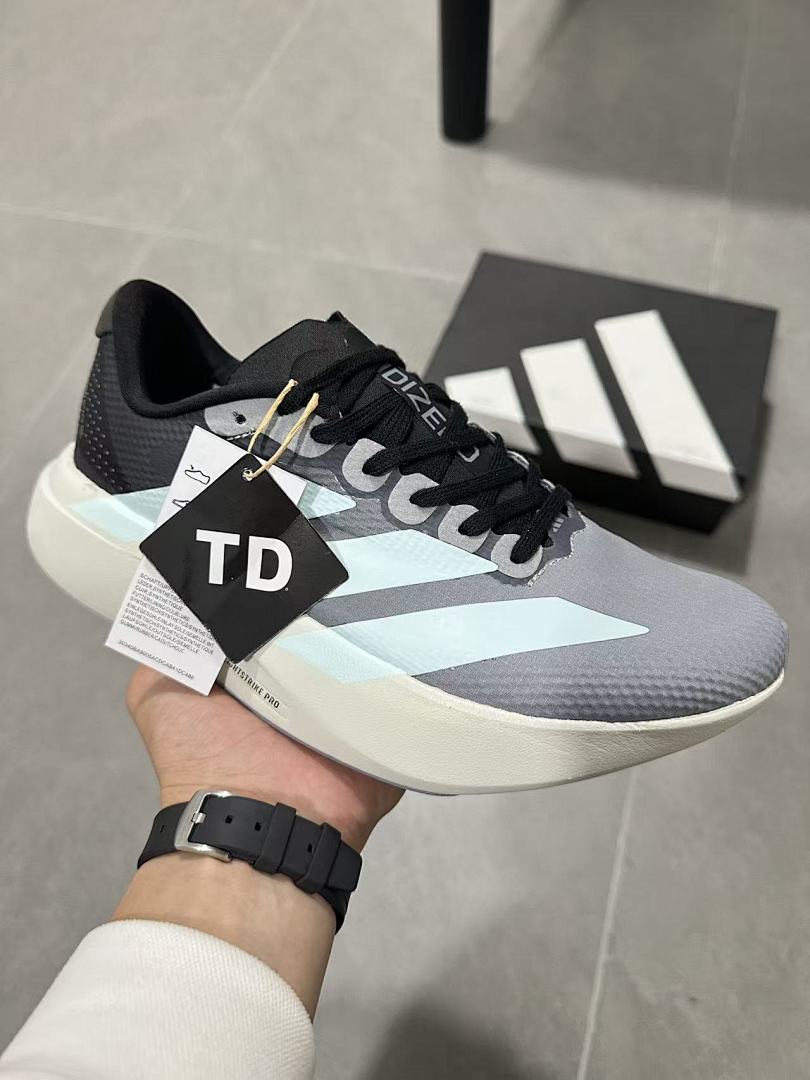 Gray and Blue Adidas Lightstrike Pro Running Shoes - product image from the listing.