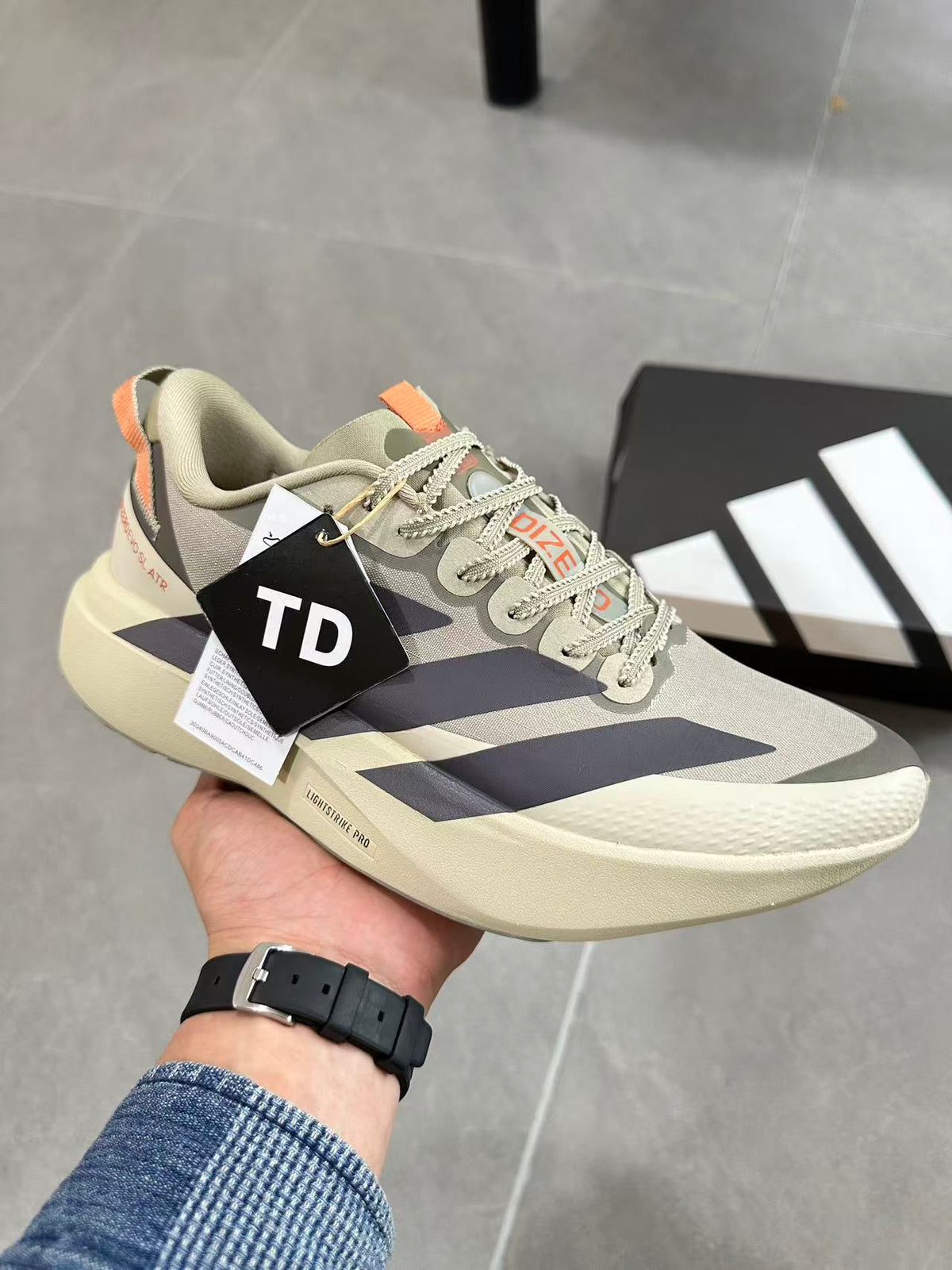 Adidas Adizero Lightstrike Pro Running Shoes, in Cream and Navy - product image from the listing.