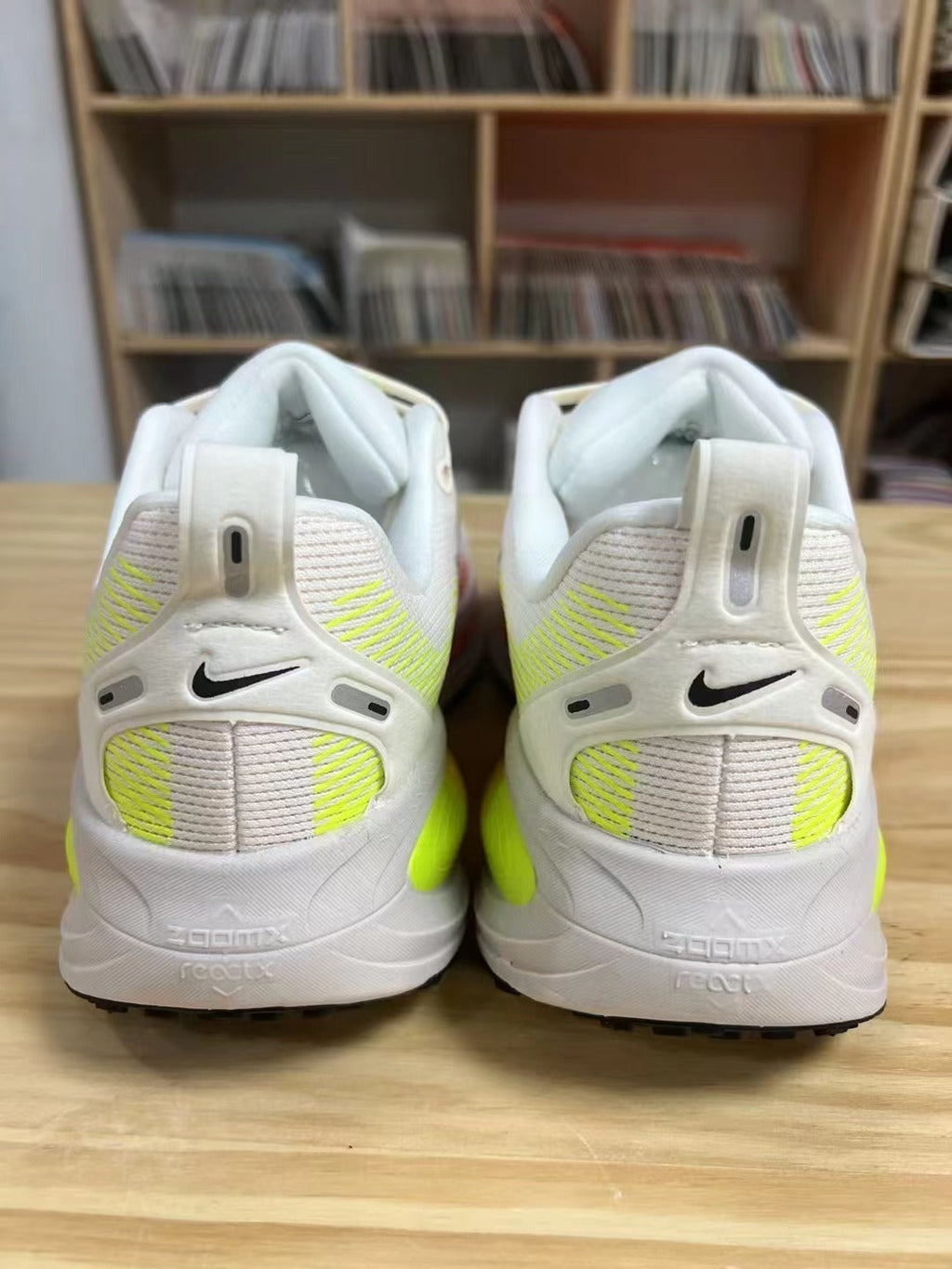 Nike Vomero 18 Running Shoes in White Volt Orange - product image from the listing.