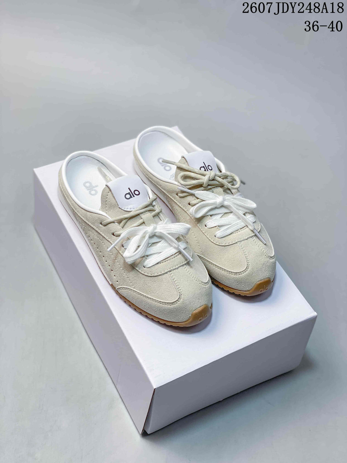 alo Sunset Mule Sneakers in Pink, in Navy and Cream - product image from the listing.