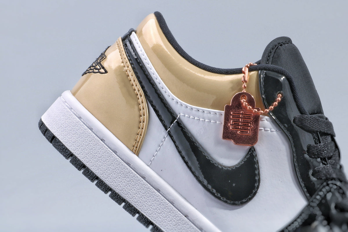 Jordan 1 Low Gold Toe Sneakers in Black and Metallic Gold - product image from the listing.