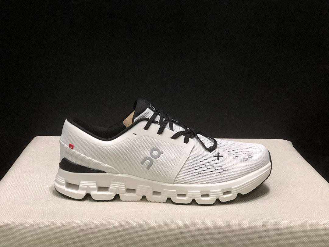 On Cloud X 4 Sneakers in Ivory and Black - product image from the listing.