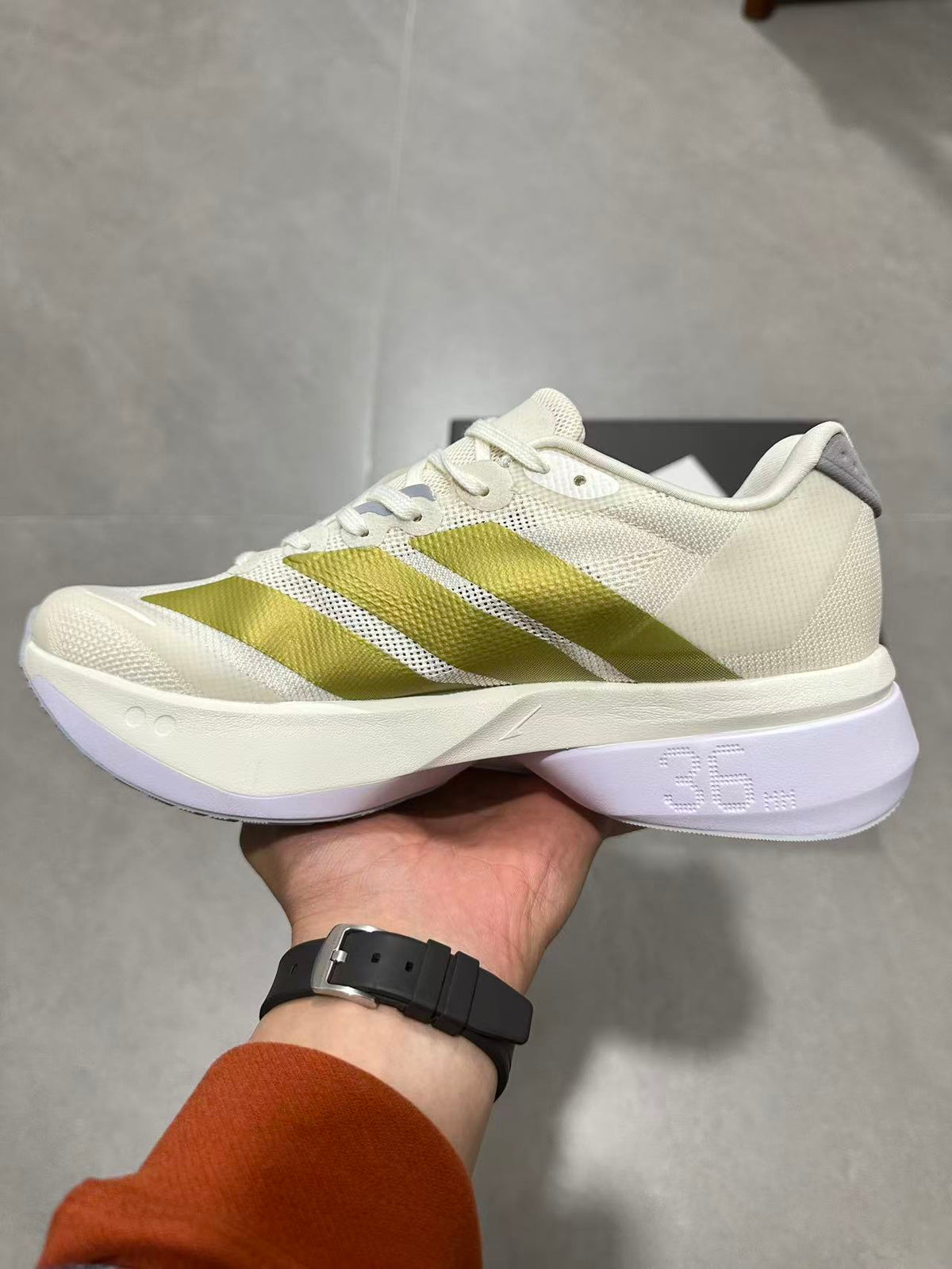 Adizero Lightstrike Pro Running Shoes in White and Olive JS4947 - product image from the listing.