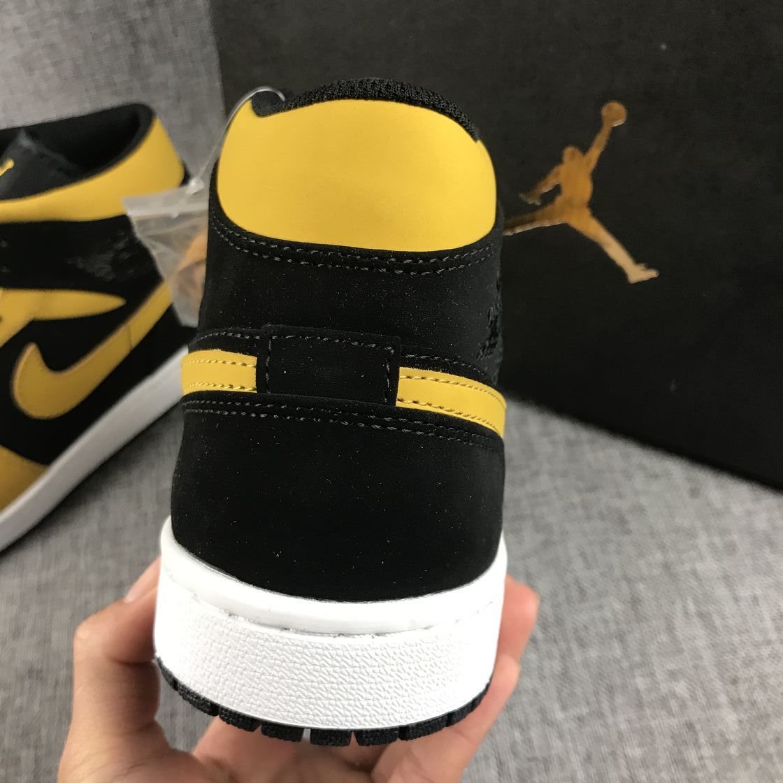 Air Jordan 1 Mid Sneakers in Black and Yellow - product image from the listing.