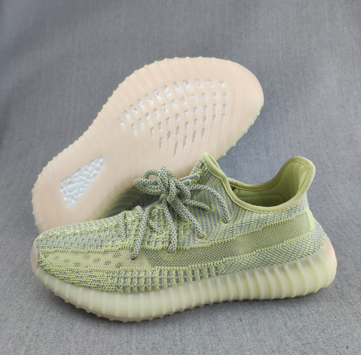 Pale Yellow and Gray Yeezy 350 V2 Knit Sneakers - product image from the listing.