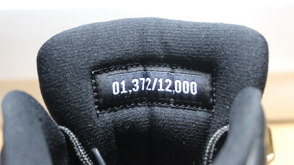 Air Jordan 12 Wings Black White Gold Sneakers 848692-033 - product image from the listing.