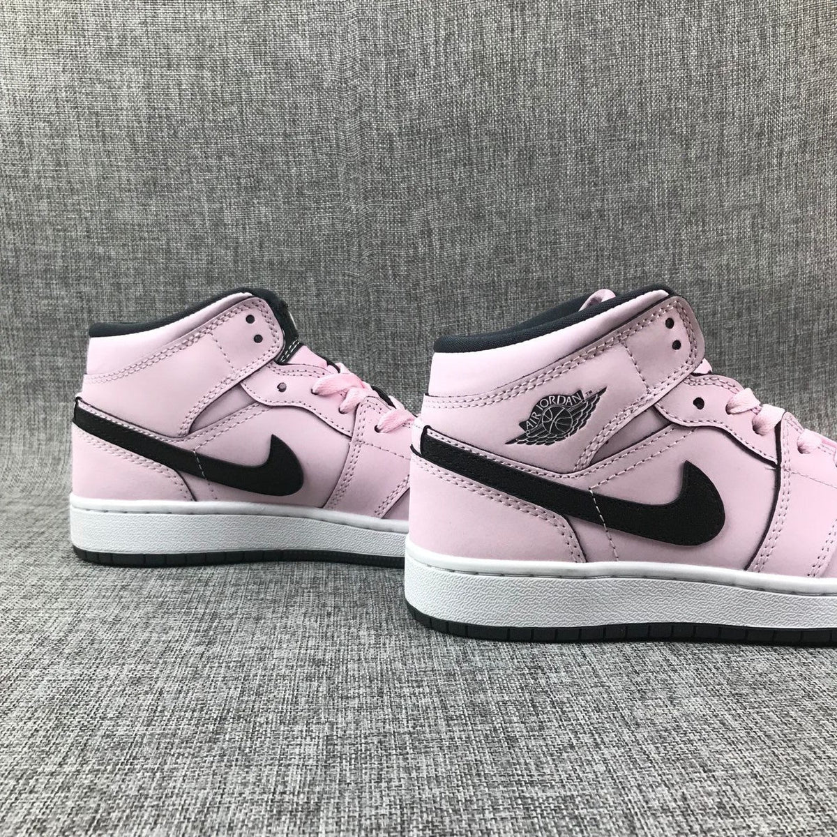 Air Jordan 1 Mid High-Top Sneakers in Pink and Black - product image from the listing.