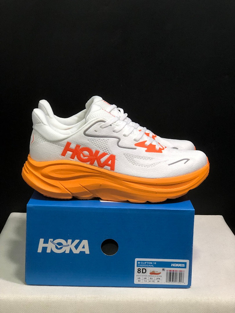 White and Orange HOKA Clifton 10 Running Shoes - product image from the listing.