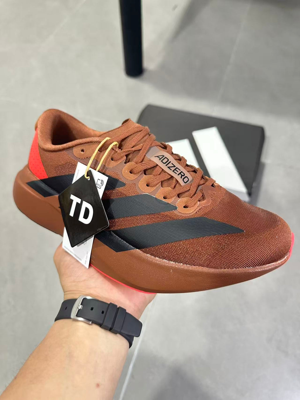 Adizero Lightstrike Pro Running Shoes, in Brown and Black KJ8809 - product image from the listing.