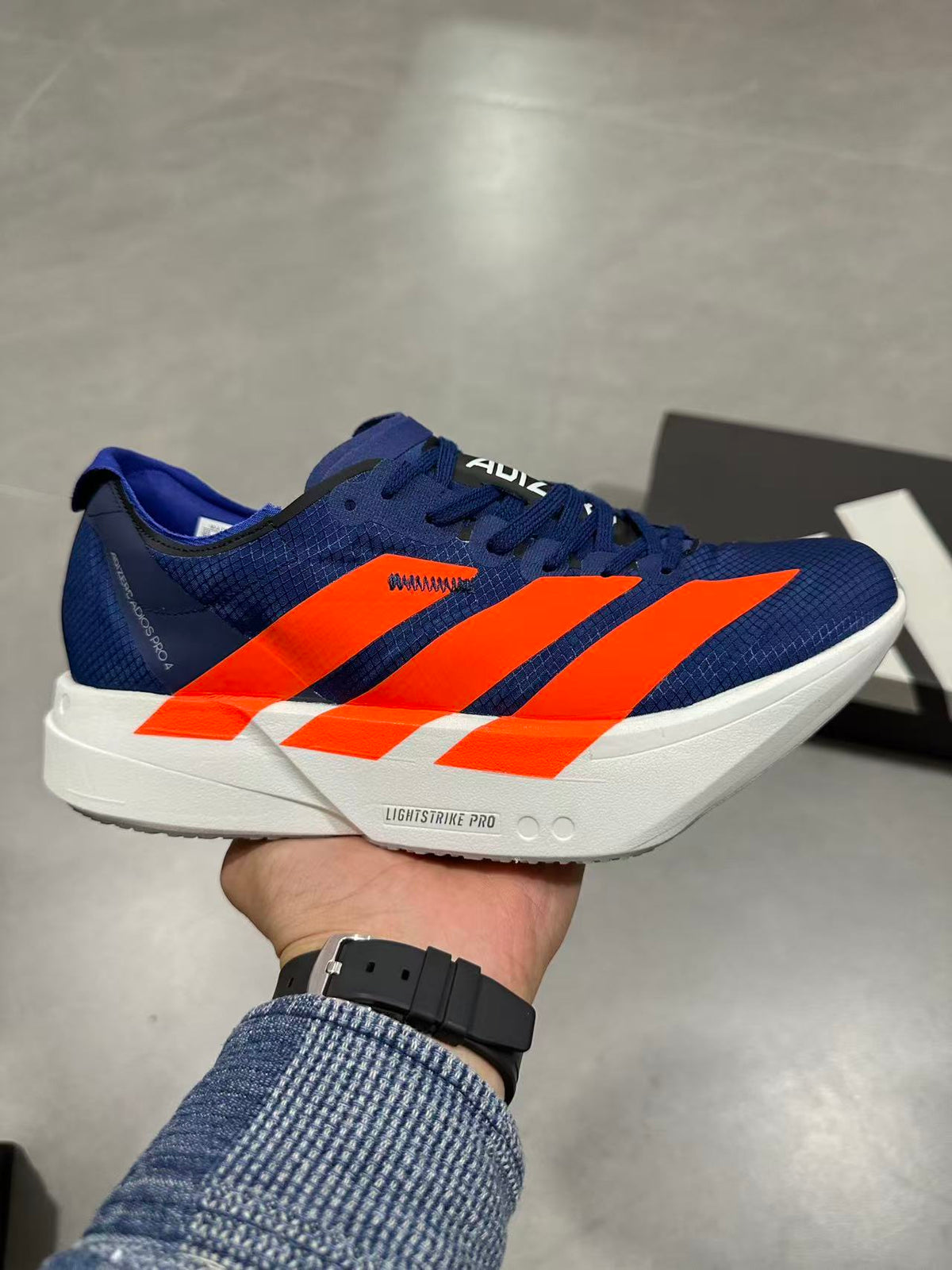 Nike Adizero Lightstrike Pro Running Shoes, in Navy and Orange - product image from the listing.