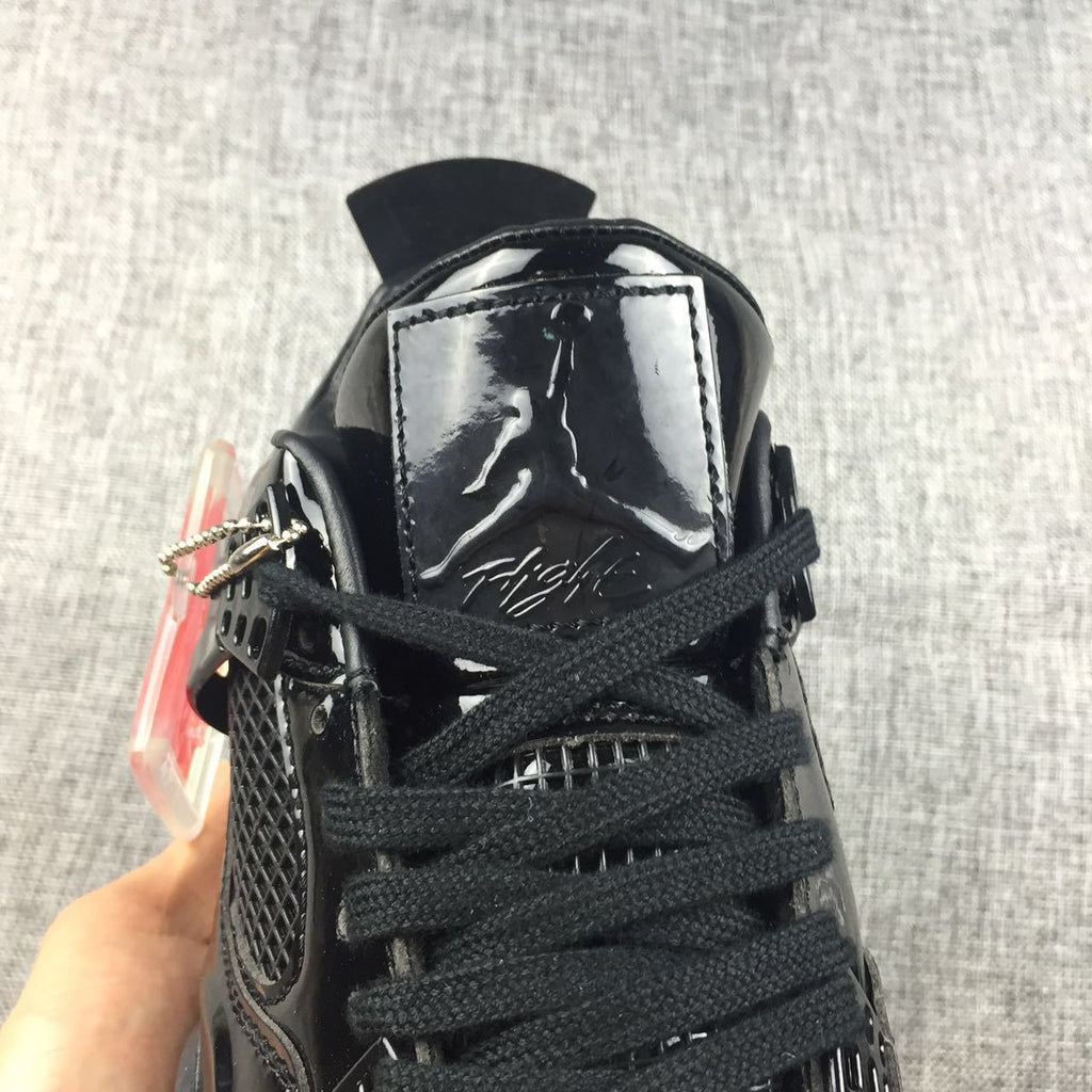 Air Jordan 4 Black Glossy Sneakers - product image from the listing.