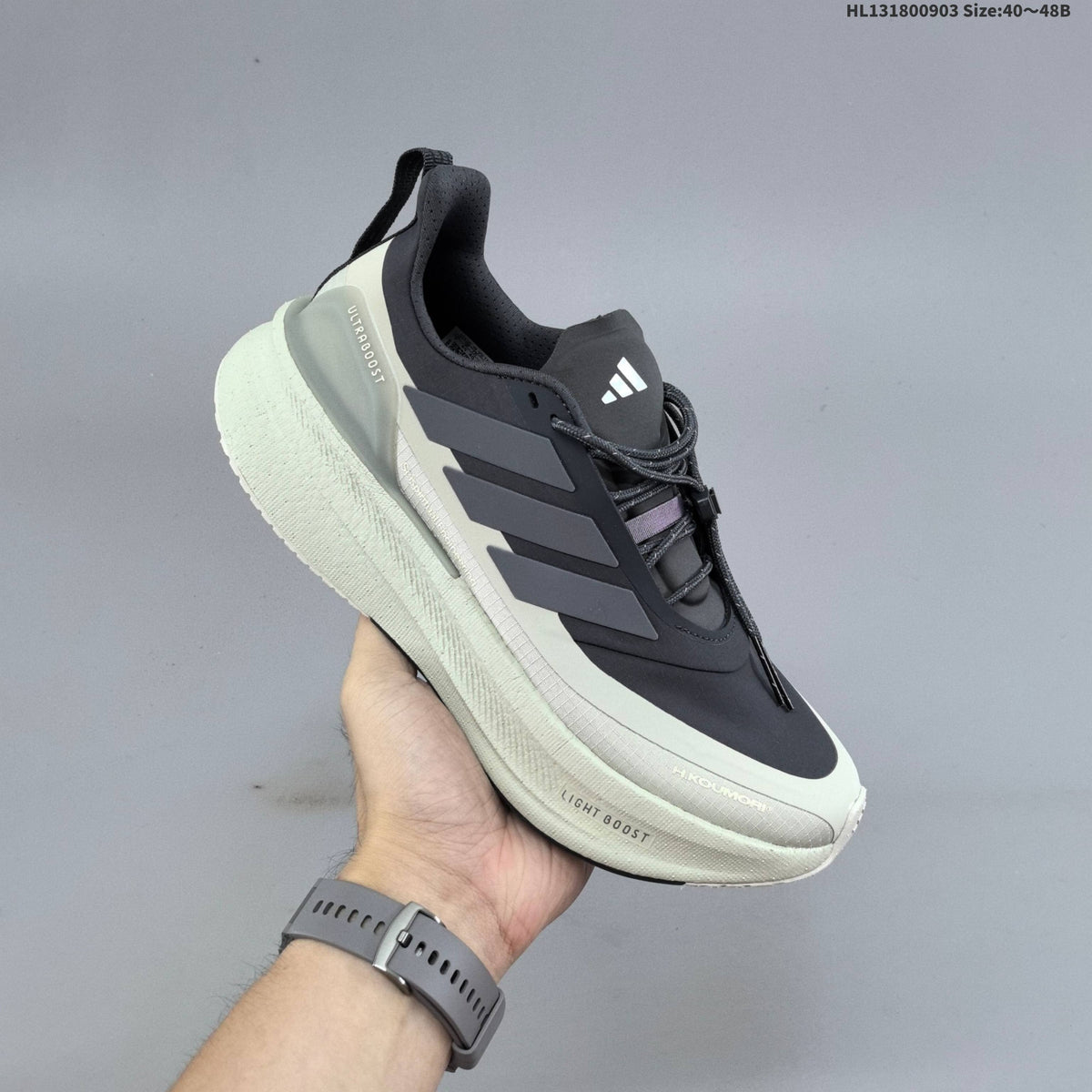 Adidas Ultraboost 5 Running Shoes, in Charcoal and Cream - product image from the listing.