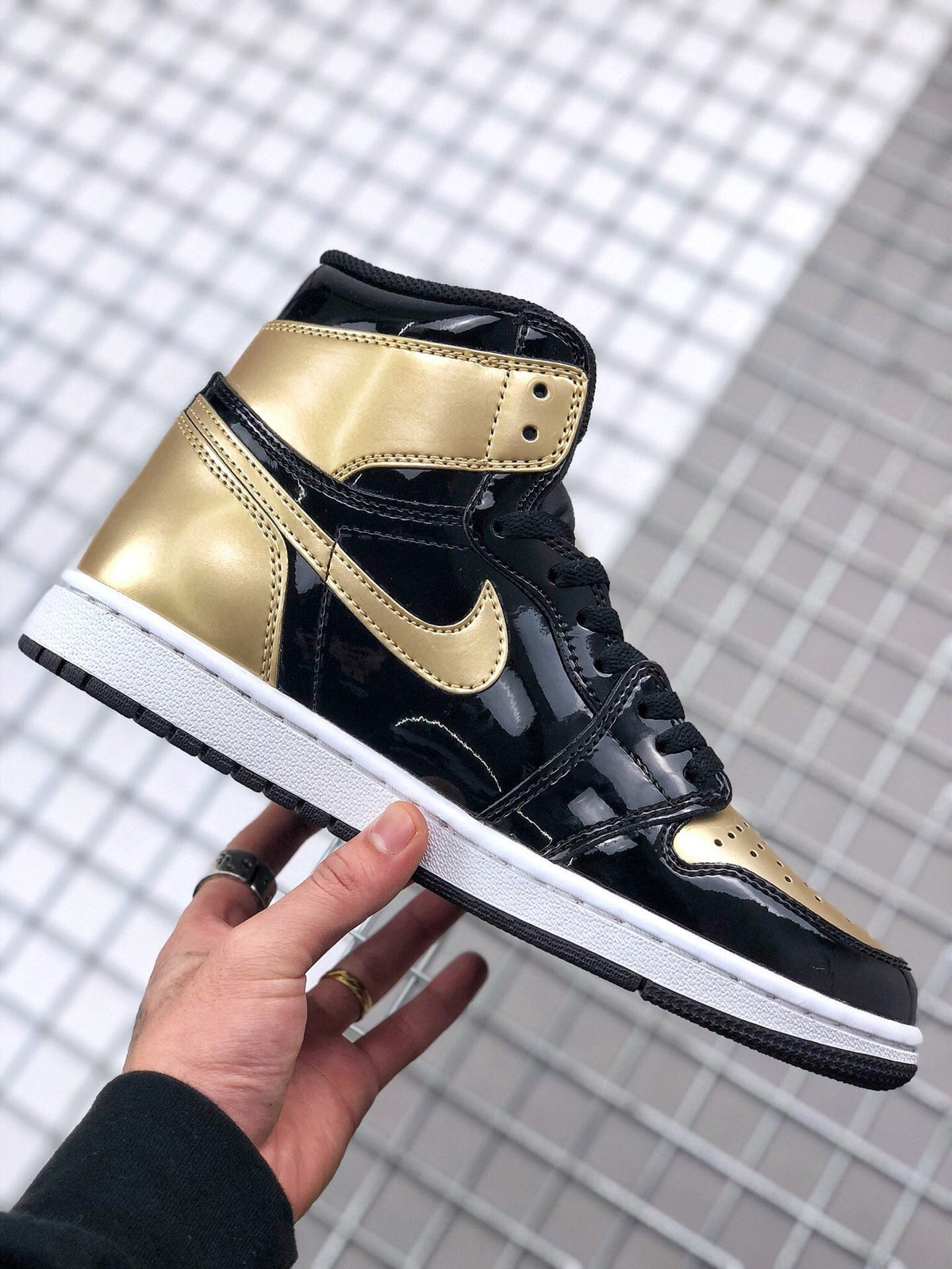 Air Jordan 1 High Gold Toe Sneakers in Black and Gold - product image from the listing.