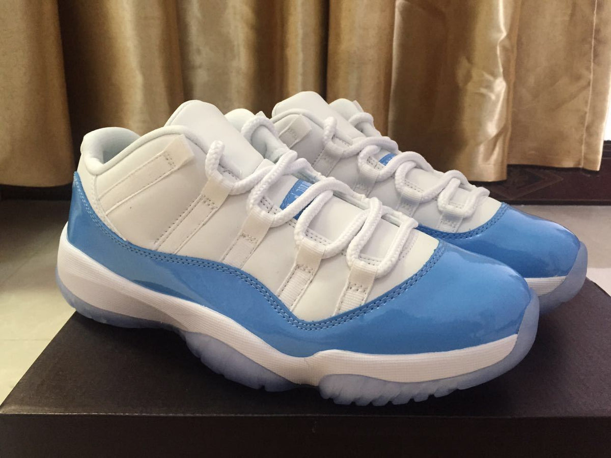 White and University Blue Jordan 11 Low Sneakers - product image from the listing.