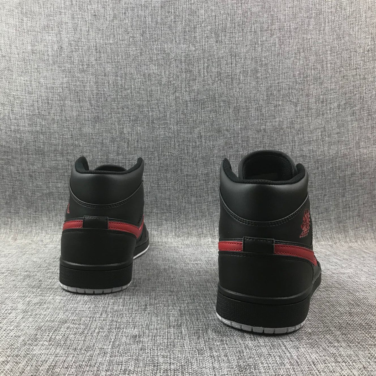 Air Jordan 1 Mid Sneakers in Black and Red 554724-045 - product image from the listing.