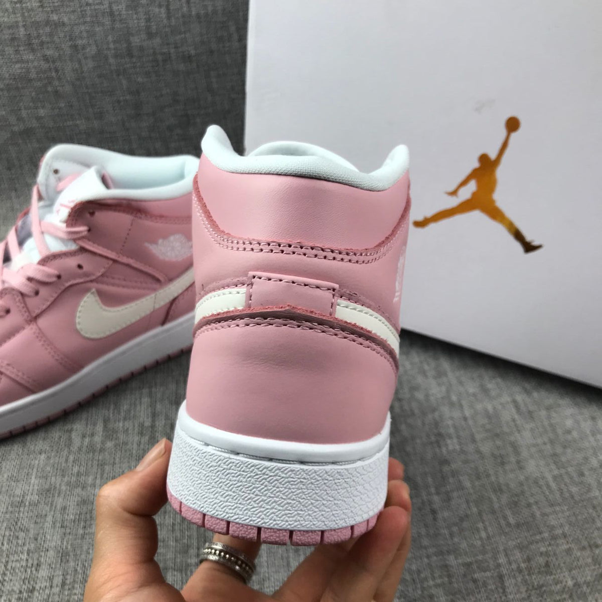 Women's Jordan 1 Mid Pink Sneakers 555112-100 - product image from the listing.