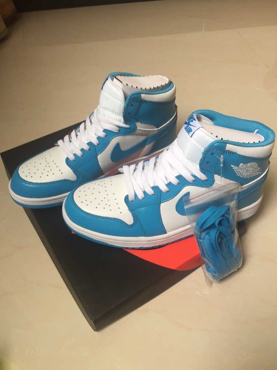 Jordan 1 High Sneakers in White and Blue - product image from the listing.