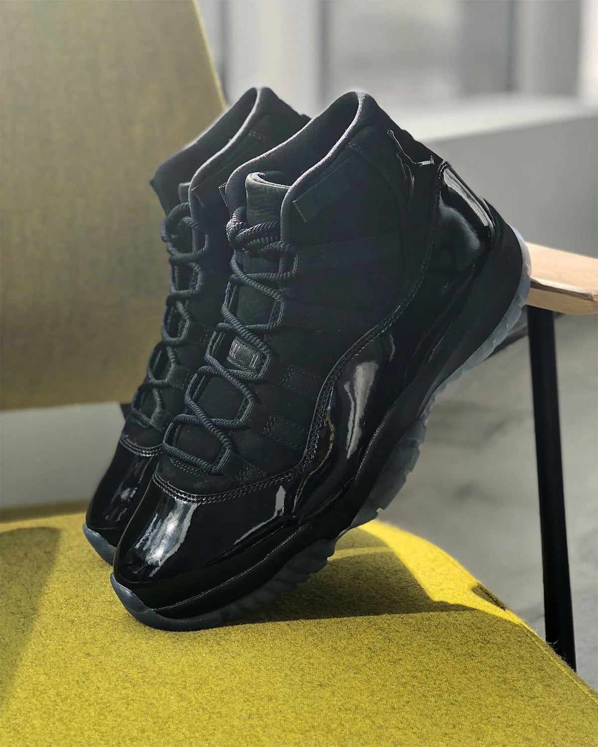 Air Jordan 11 Cap and Gown High-Top Sneakers in Black - product image from the listing.