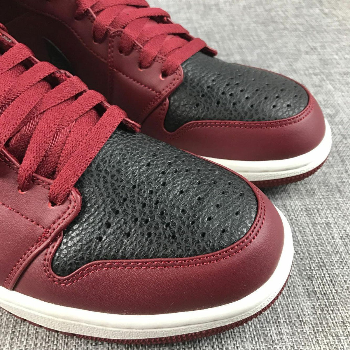 Air Jordan 1 Mid Sneakers in Black and Burgundy 554724-601 - product image from the listing.
