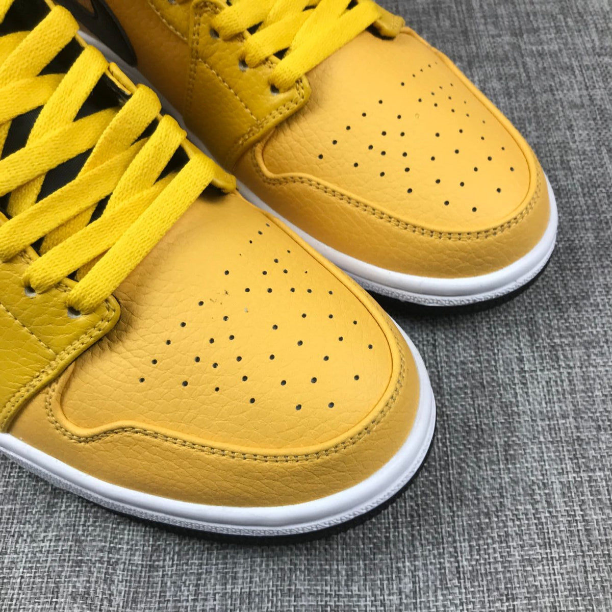 Air Jordan 1 Mid Yellow Ochre Sneakers in Black 554724-700 - product image from the listing.