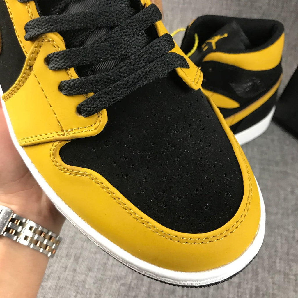 Air Jordan 1 Mid Sneakers in Black and Yellow - product image from the listing.