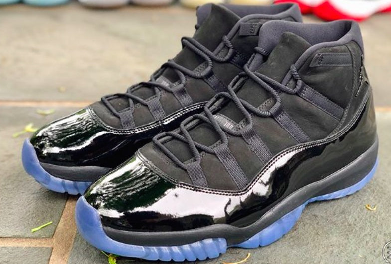 Air Jordan 11 Cap and Gown High-Top Sneakers in Black - product image from the listing.