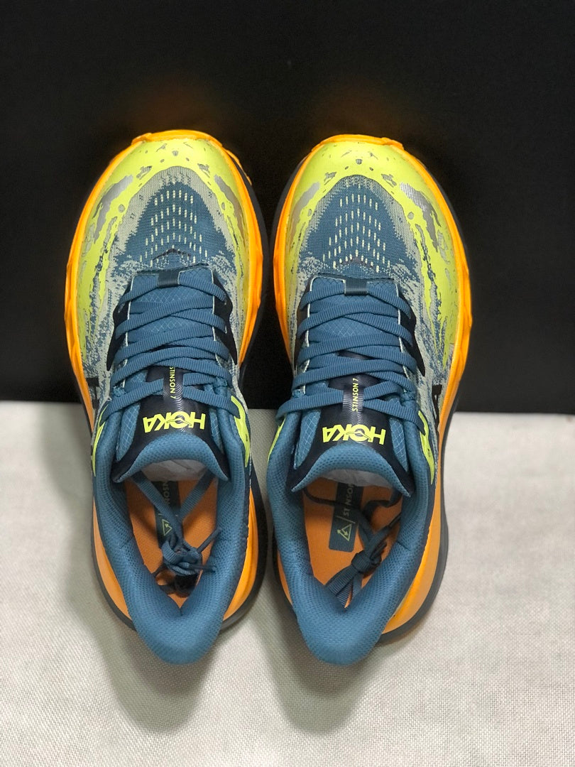 HOKA Stinson 7 Trail Running Shoes in Blue Yellow Orange - product image from the listing.