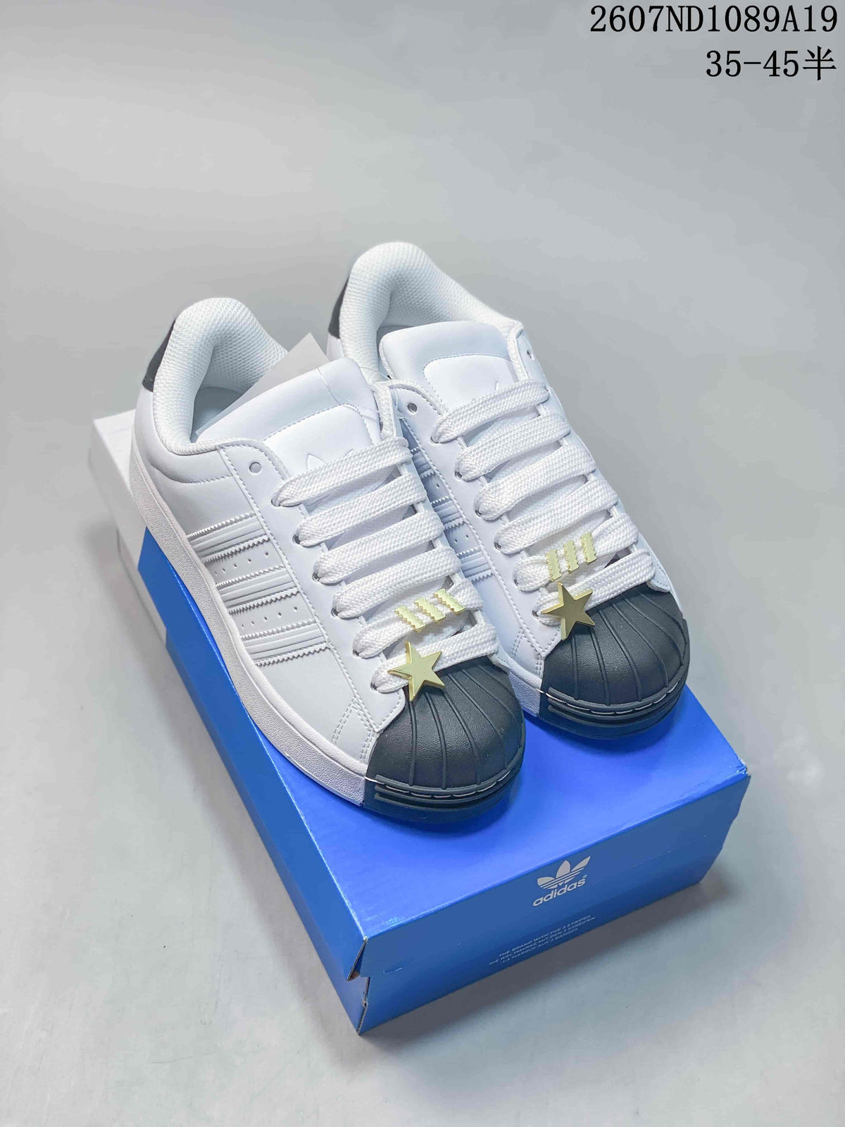 adidas Superstar Shell-Toe Sneakers in Black and White - product image from the listing.