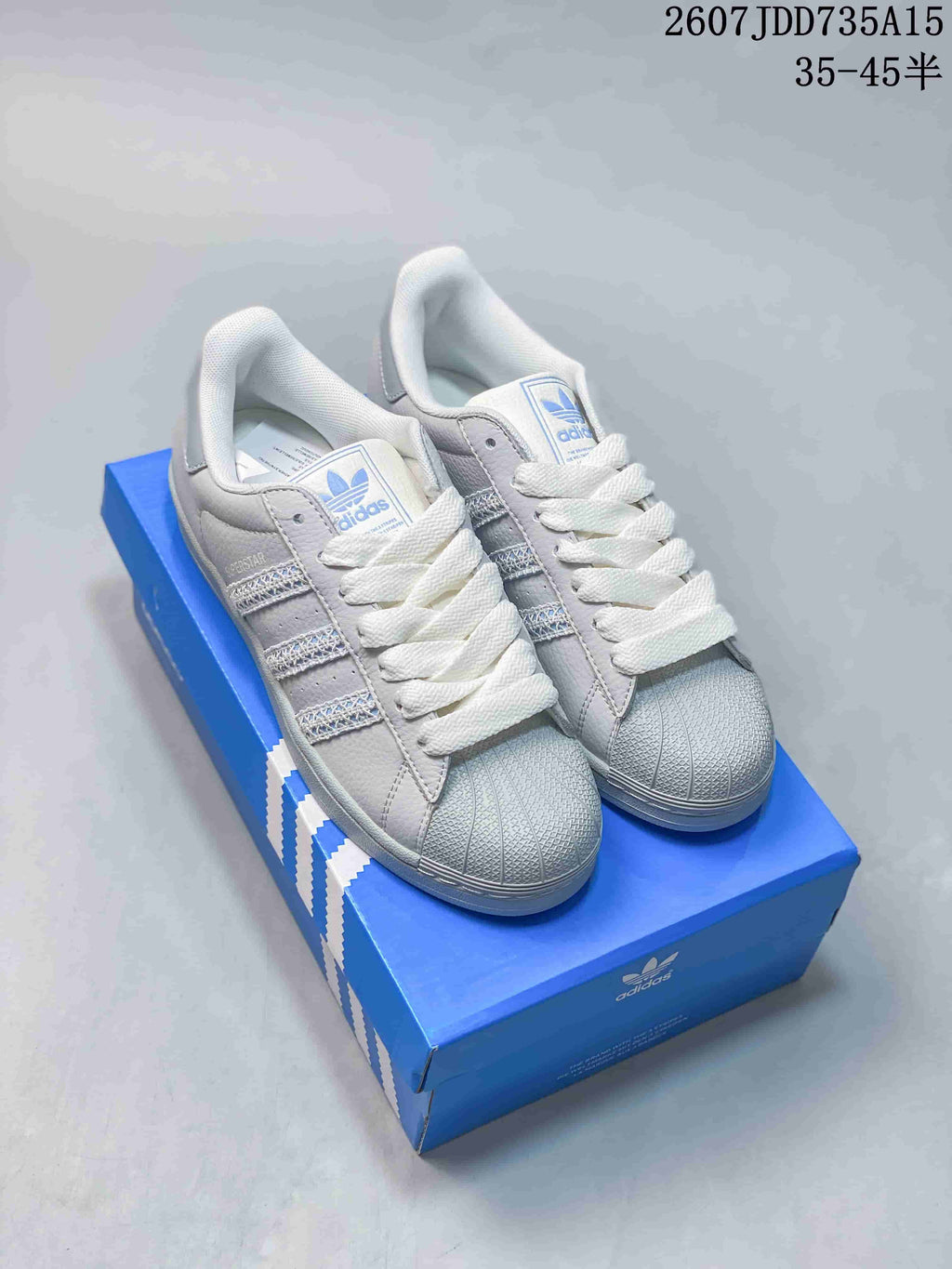 adidas Superstar Sneakers in White Gray Blue 2607JDD735A15 - product image from the listing.