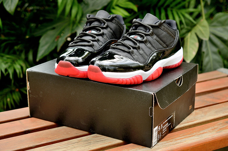 Air Jordan 11 Retro Low Black and Red Sneakers - product image from the listing.