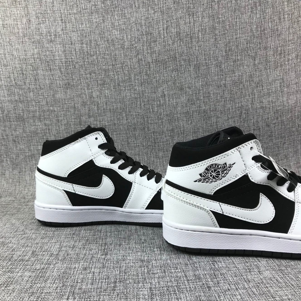 Air Jordan 1 Mid Black White Sneakers 554724-113 - product image from the listing.