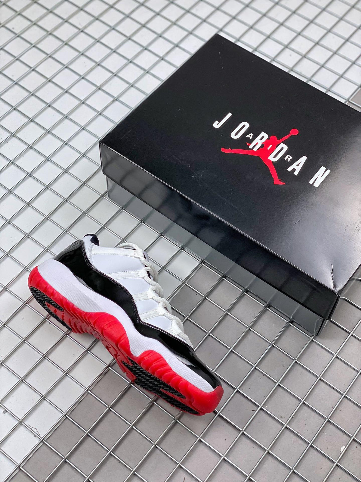 Air Jordan 11 Win Like '82 Sneakers in White Black Red - product image from the listing.