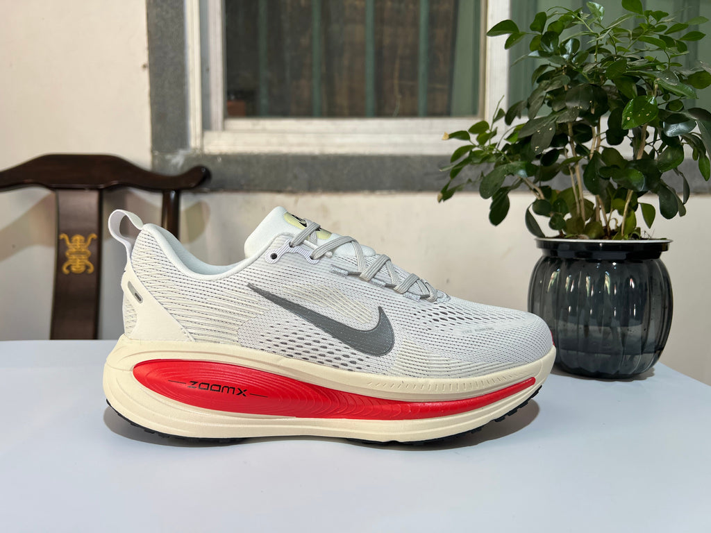 Nike Vomero 18 Running Shoes in White and Red - product image from the listing.