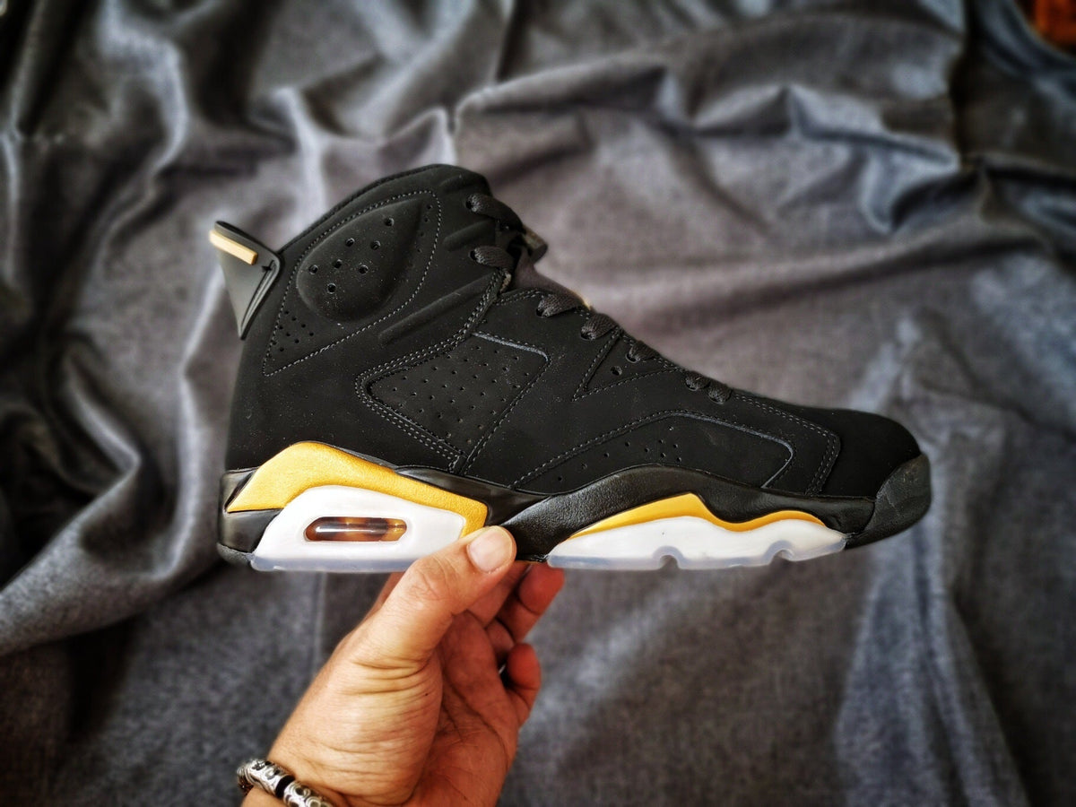 Air Jordan 6 High-Top Sneakers in Black and Gold - product image from the listing.