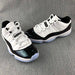 White and Black Jordan 11 Low Sneakers - product image from the listing.