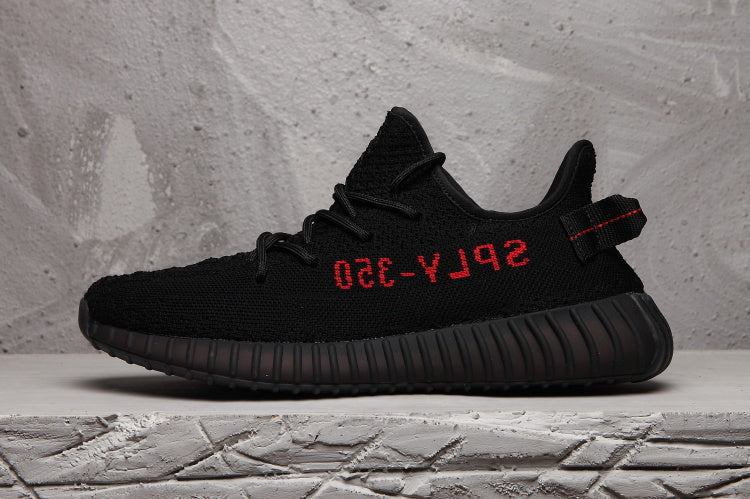 Yeezy Boost 350 V2 Black Knit Trainers with Red Accents - product image from the listing.