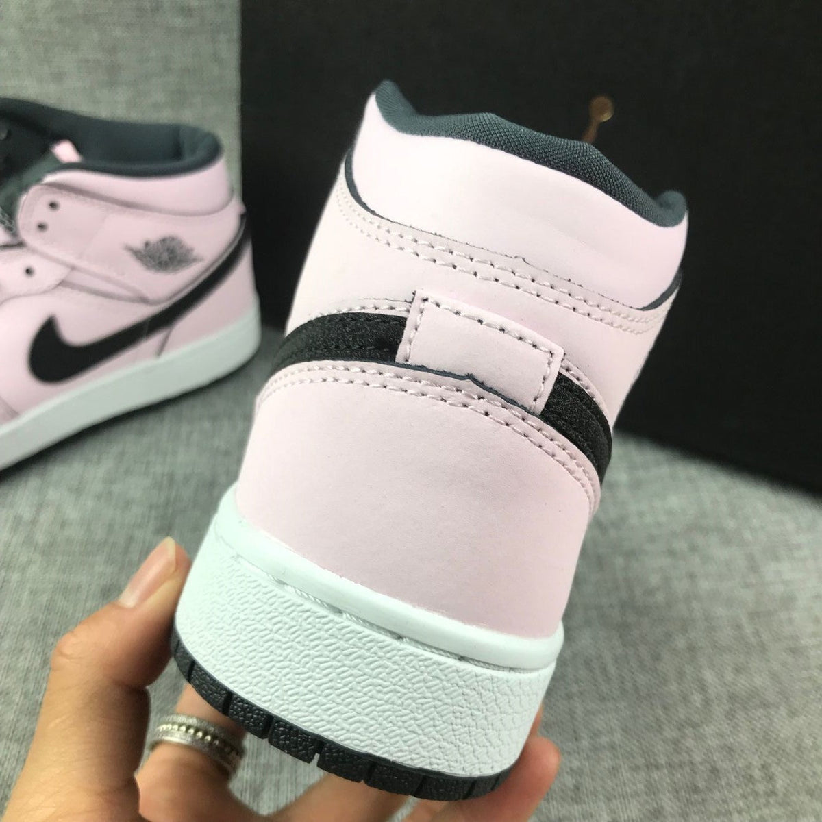 Air Jordan 1 Mid High-Top Sneakers in Pink and Black - product image from the listing.